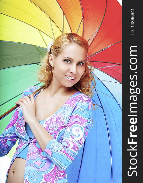 Beautiful pregnant girl with a rainbow umbrella