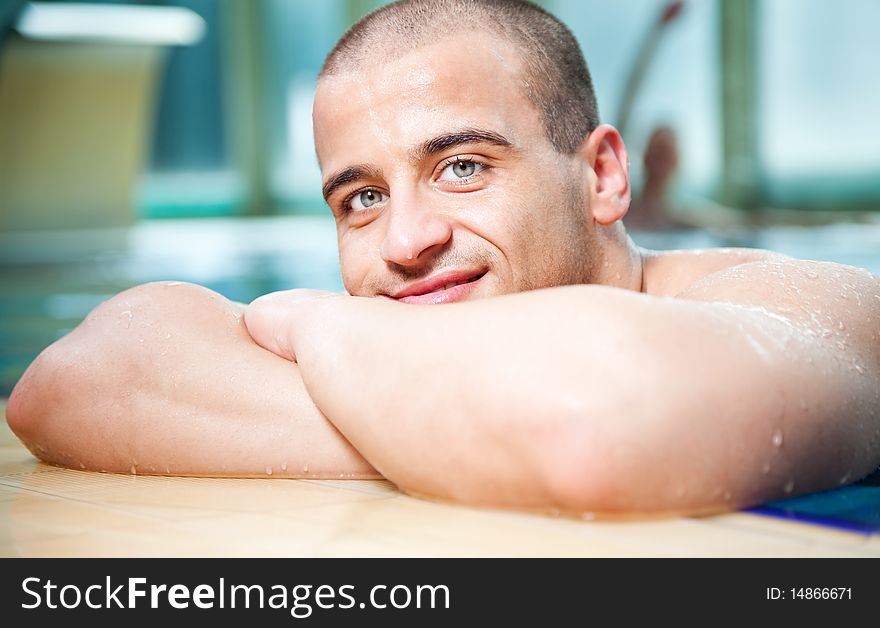 Close-up of young attractive male posing in a swimming pool. Close-up of young attractive male posing in a swimming pool