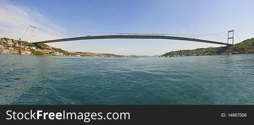 Ataturk suspension bridge spanning the Bosphorus river in Istanbul, Turkey against a blue sky. Ataturk suspension bridge spanning the Bosphorus river in Istanbul, Turkey against a blue sky