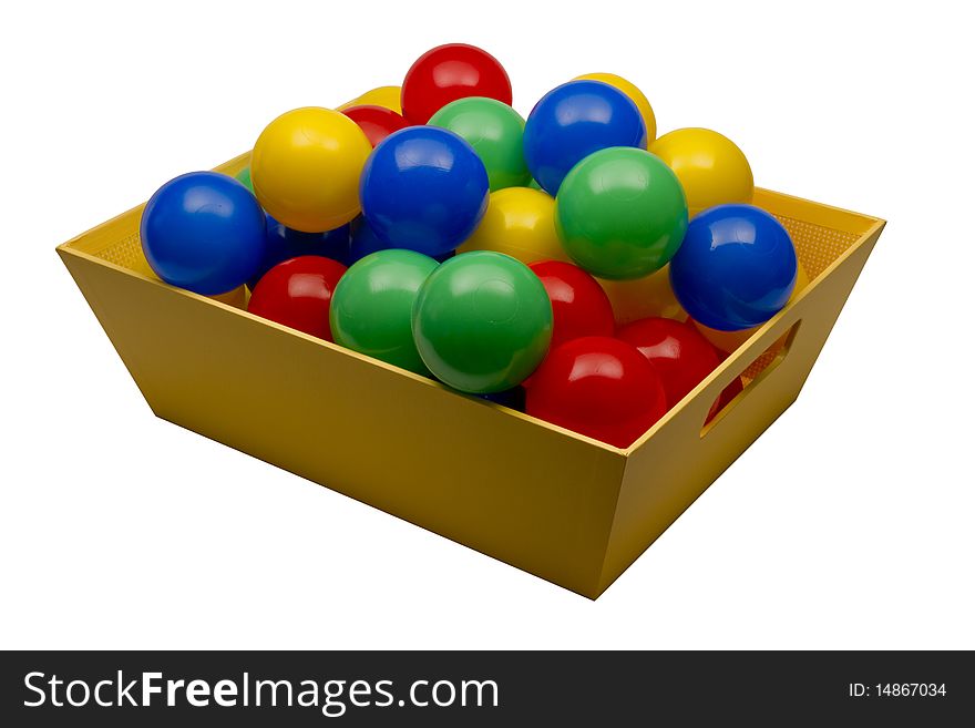 Plastic multicolored balls in the yellow basket on white background with clipping path. Plastic multicolored balls in the yellow basket on white background with clipping path
