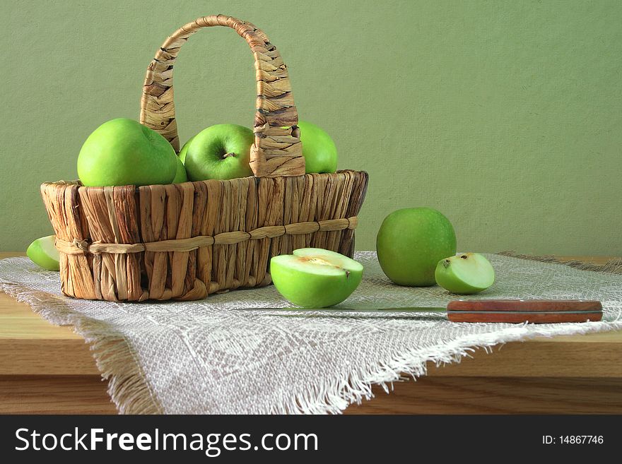 Green apples in the basket with knife. Green apples in the basket with knife