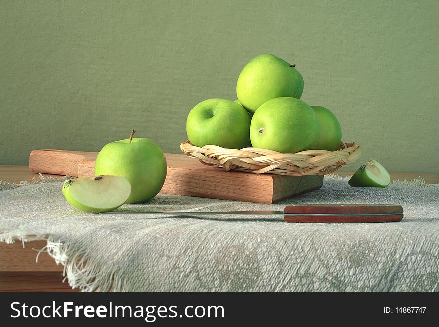 Green apples in the twist with knife. Green apples in the twist with knife