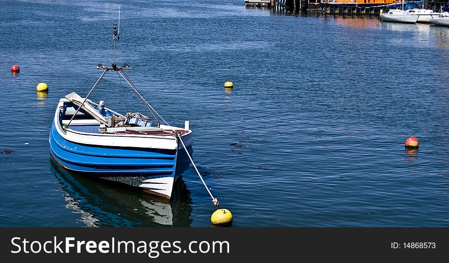 A small blue boat in Whitby harbour.