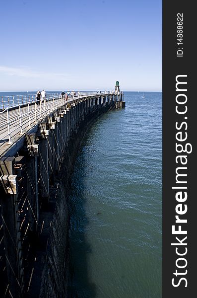 The pier at whitby jetting out into the sea. The pier at whitby jetting out into the sea.