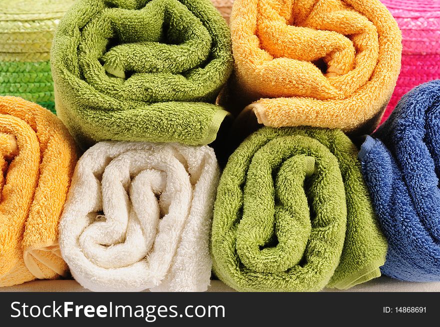 Rolled up colorful towels in straw basket. Rolled up colorful towels in straw basket