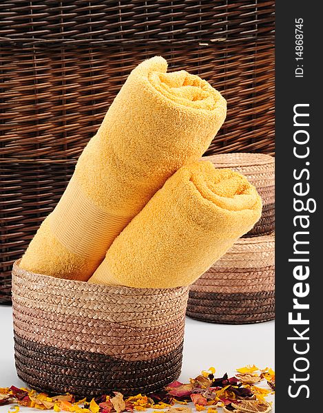 Rolled up colorful towels in straw basket. Rolled up colorful towels in straw basket