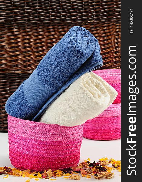 Rolled up colorful towels in straw basket. Rolled up colorful towels in straw basket