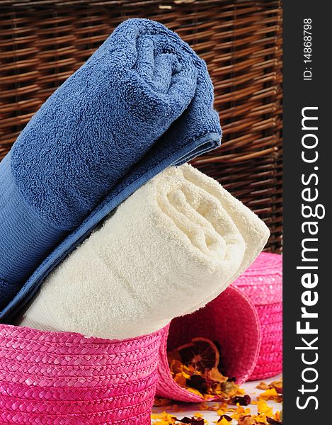 Rolled up colorful towels in straw basket. Rolled up colorful towels in straw basket