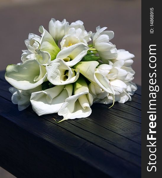 The wedding bouquet of the bride laying on shops. The wedding bouquet of the bride laying on shops