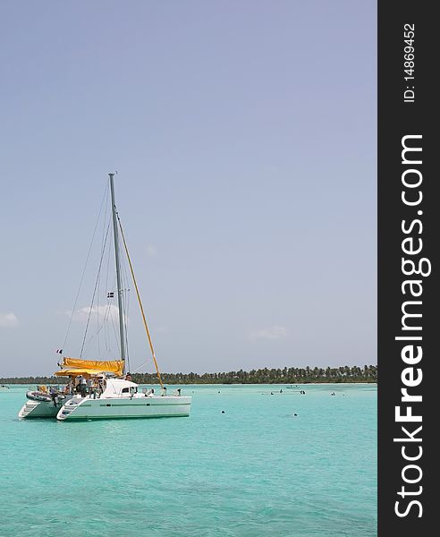 Catamaran and people swimming in Caribbean sea. Catamaran and people swimming in Caribbean sea