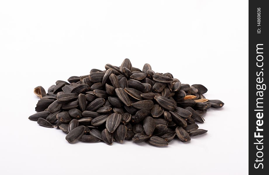The handful of sunflower's seeds on isolated white background.
