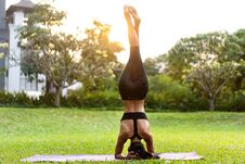 Girl Doing Yoga At Sunset In Thailand In The Park Royalty Free Stock Photography