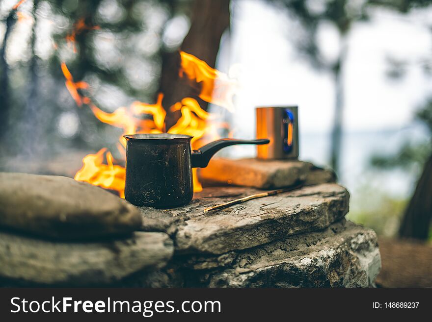 Making Coffee In Cezve On The Fireplace When Camping Or Hiking. Coffee On Campfire