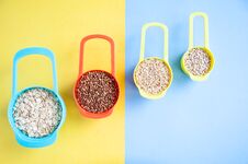 Set Of Different Cereals In Multi-colored Containers, Oatmeal Buckwheat, Royalty Free Stock Images