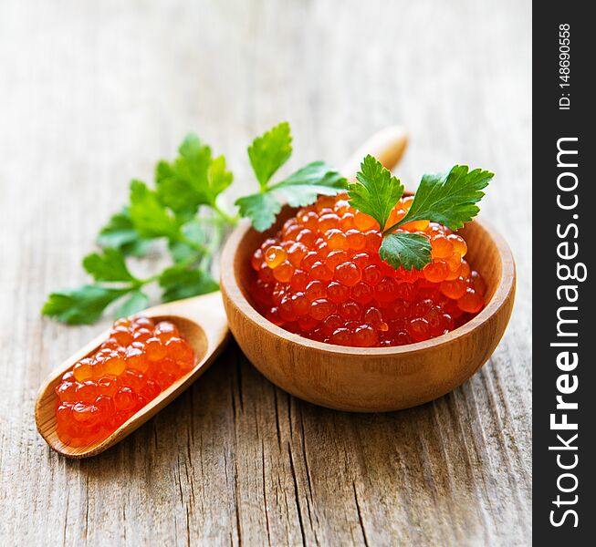 Red caviar in bowl  on a old wooden table