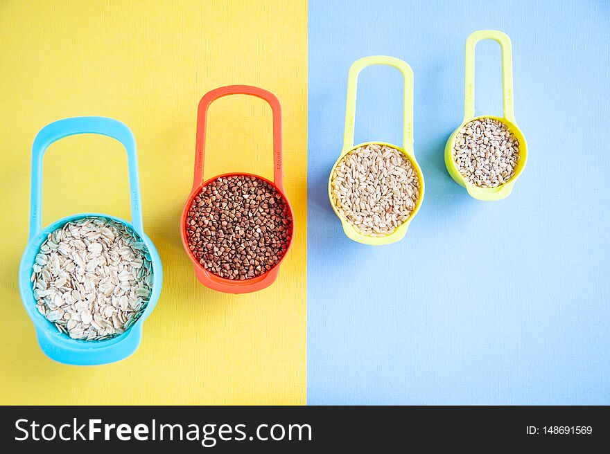 Set of different cereals in multi-colored containers, Oatmeal buckwheat