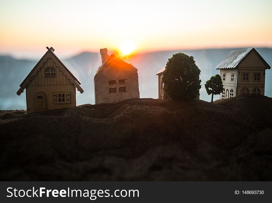 Artwork Decoration. Beautiful decorative small wooden houses on sunset background. Selective focus. Artwork Decoration. Beautiful decorative small wooden houses on sunset background. Selective focus