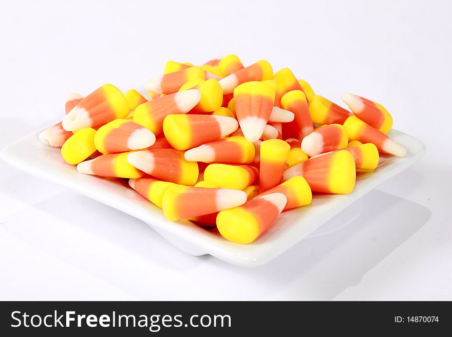 White, yellow and orange candy corn in a bowl