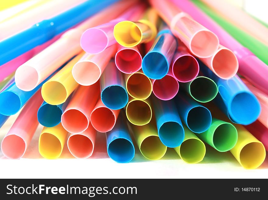 Colorful drinking straws on white