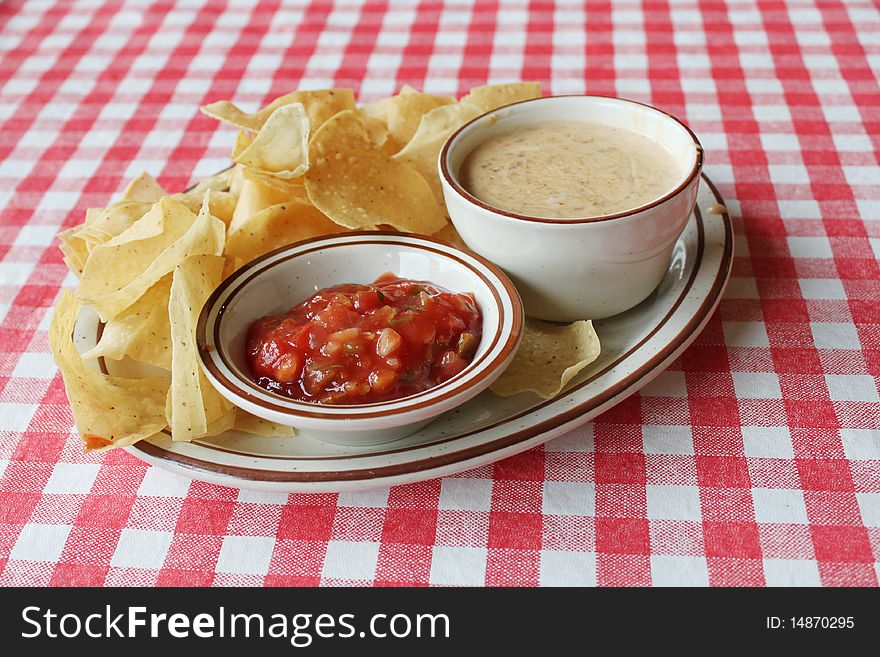 Chips, salsa and queso on table. Chips, salsa and queso on table