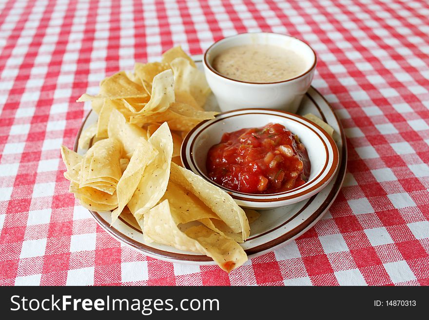 Chips, queso and salsa on table. Chips, queso and salsa on table