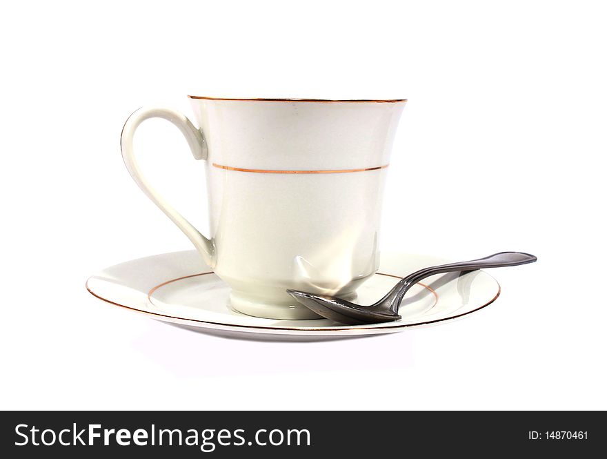 White cup with saucer and spoon