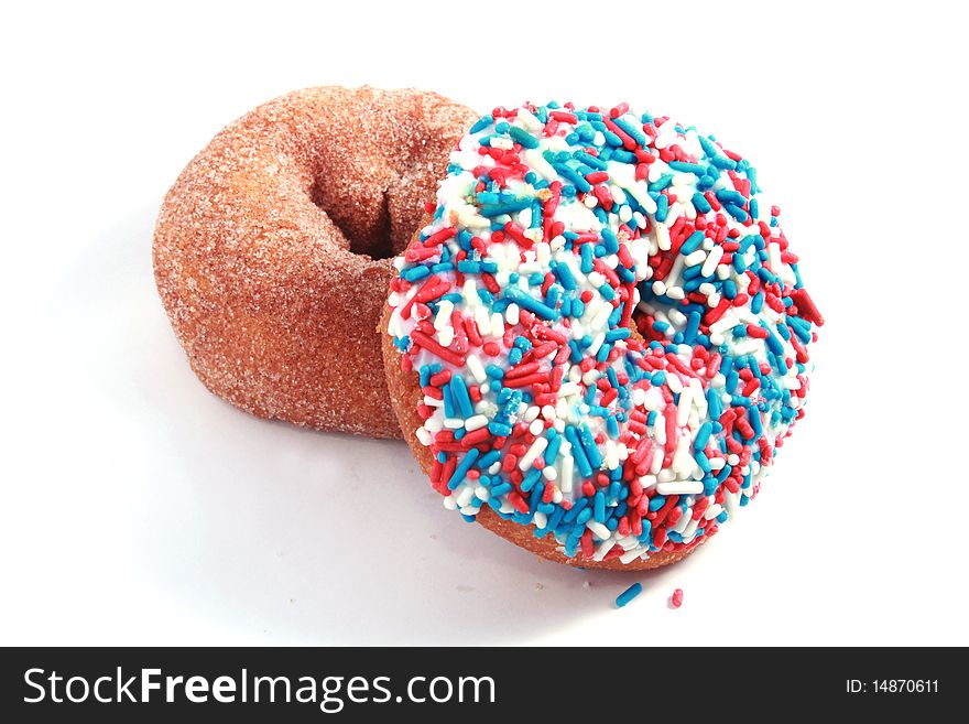 Blue, red and white donut resting on a sugar donut. Blue, red and white donut resting on a sugar donut