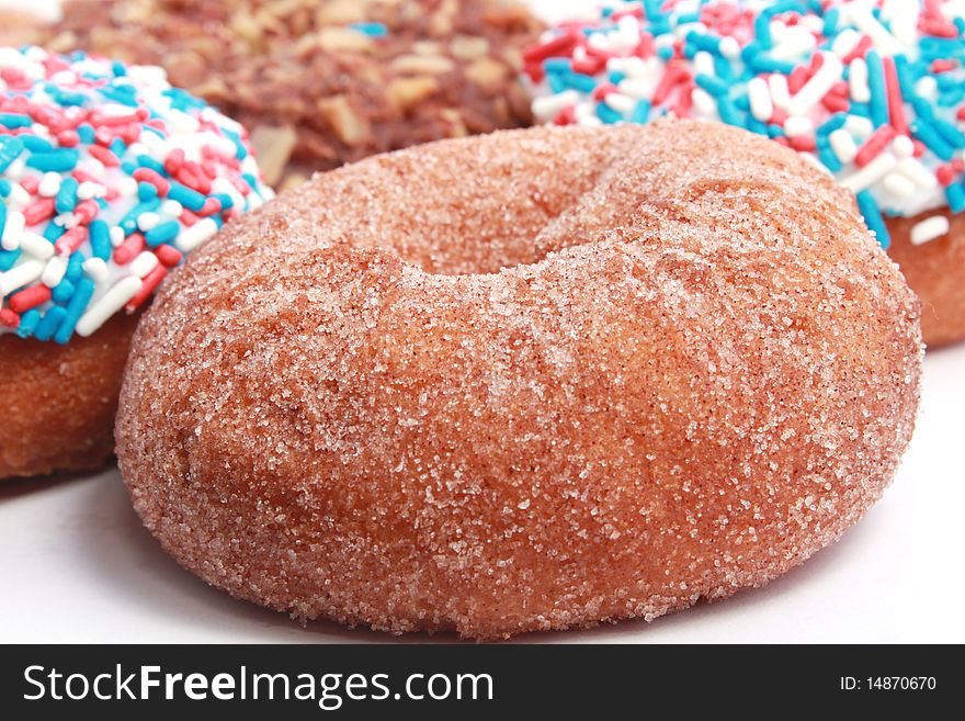 Many donuts with sugar and sprinkles