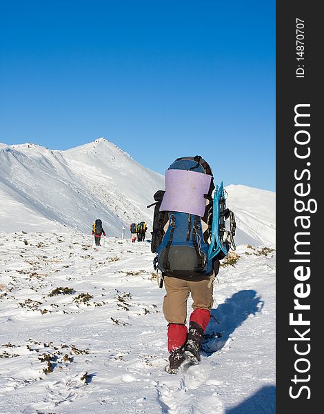 Hiker in winter in mountains