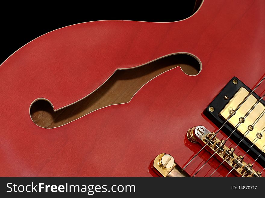 Close up of the body of a red semi hollow electric guitar. Close up of the body of a red semi hollow electric guitar