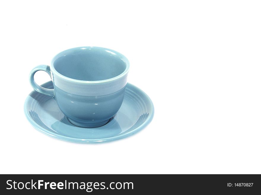 Light blue cup with saucer on white