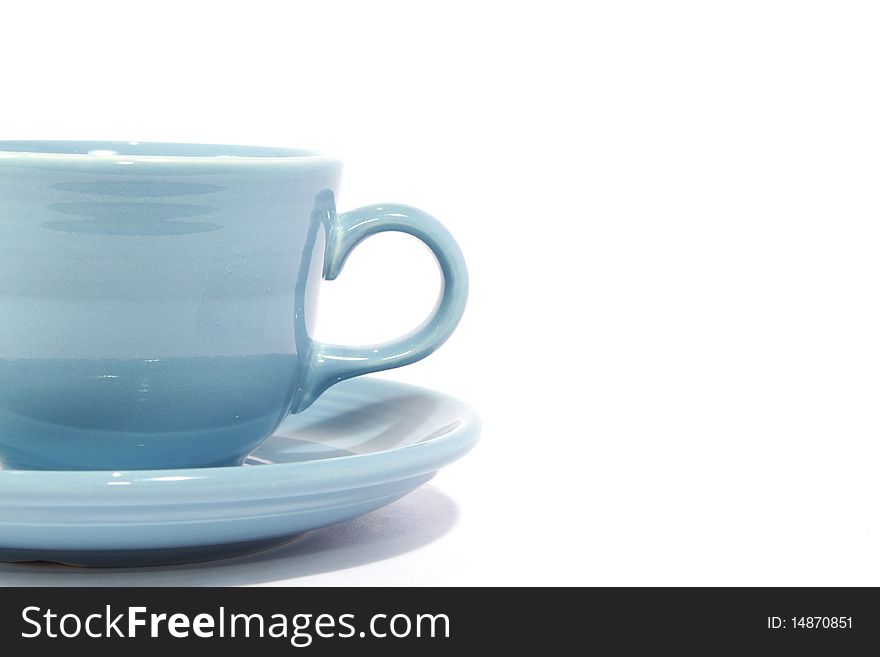 Light blue cup with saucer on white