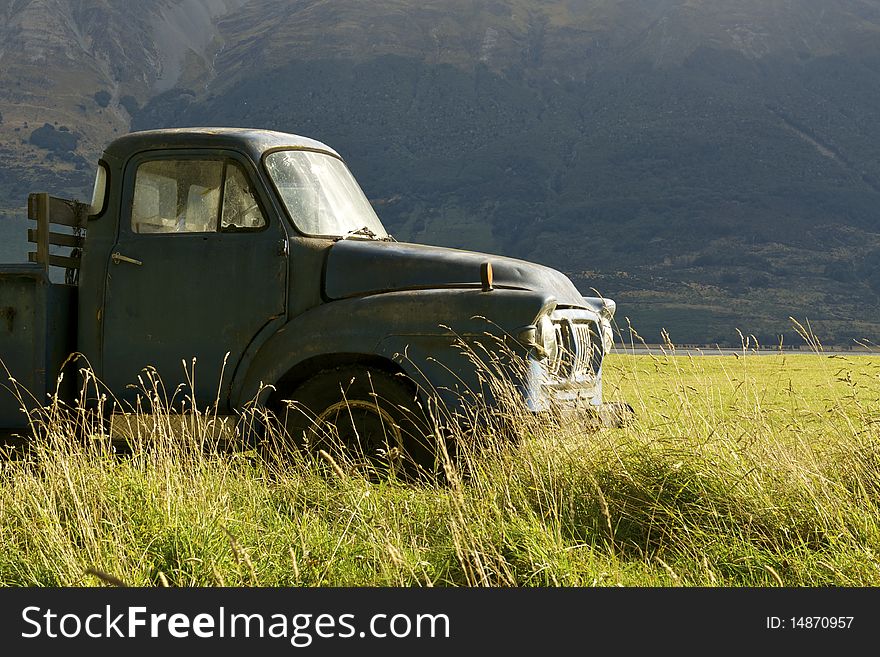 An old pickup truck in a grassy field. An old pickup truck in a grassy field