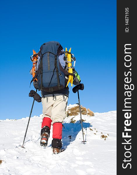 Hiker in winter in mountains