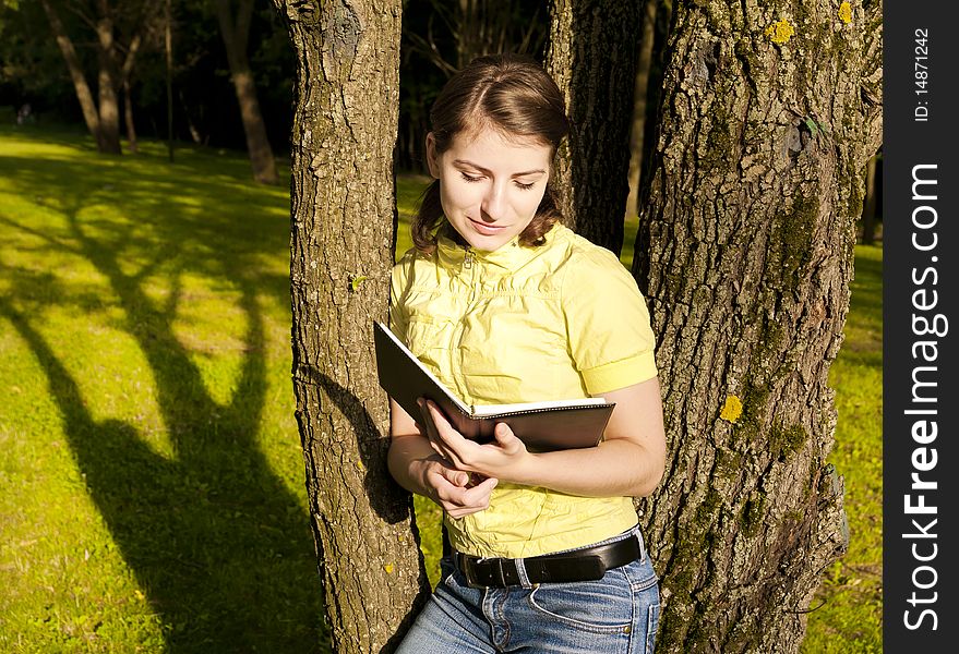 This photo shows a girl with a book