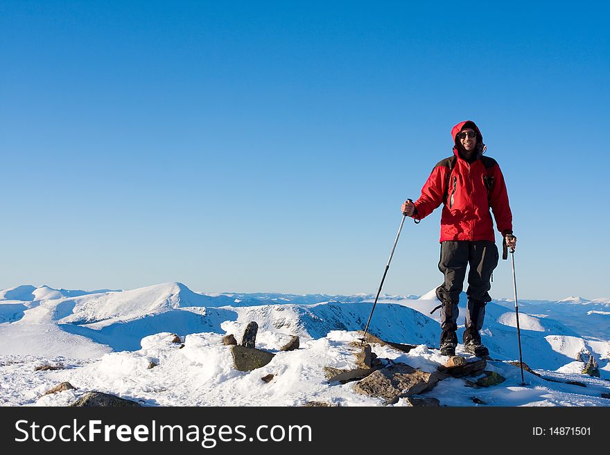 Hiker in winter in mountains