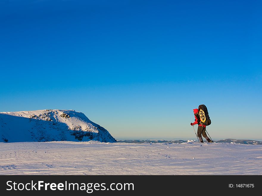 Hiker in winter in mountains