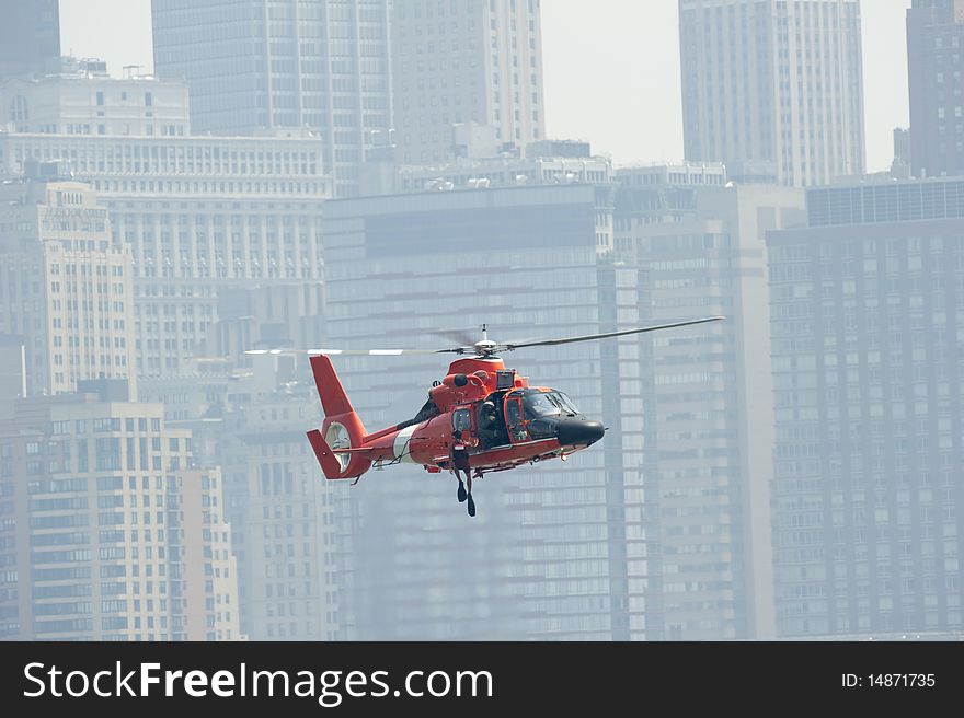 US coast guard performing a water rescue on the Hudson River with the Manhattan skyline in the background. US coast guard performing a water rescue on the Hudson River with the Manhattan skyline in the background