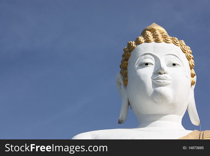 White buddha statue on blue clear sky