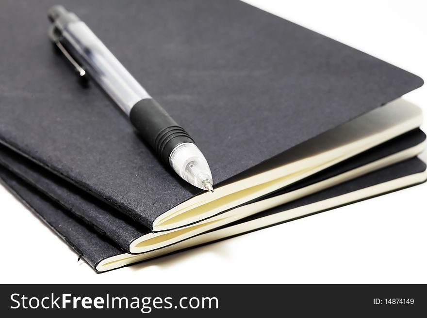 Three Sketchbooks stacked with a mechanical pencil on top. Three Sketchbooks stacked with a mechanical pencil on top