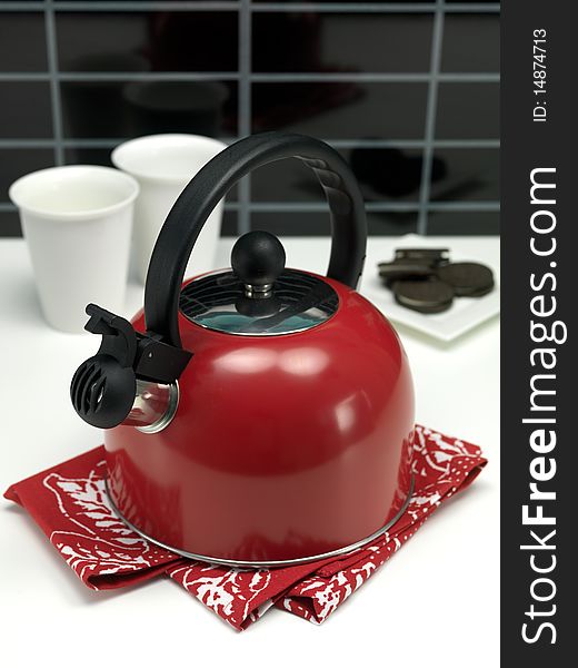 A stove top kettle on a kitchen bench