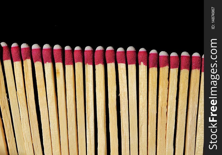 A bunch of wooden matches isolated on a black background. A bunch of wooden matches isolated on a black background