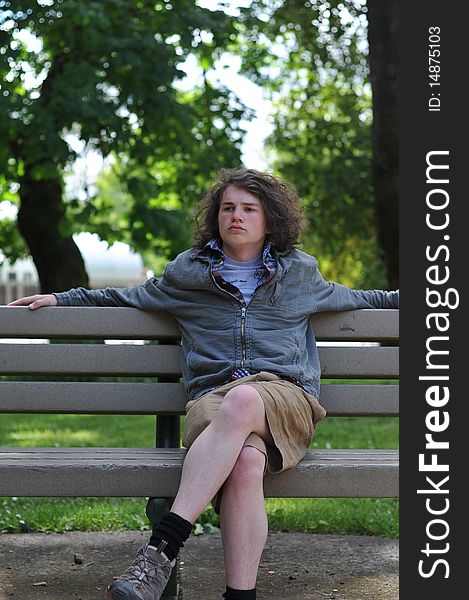 Teenager Sits On Bench And Relaxes