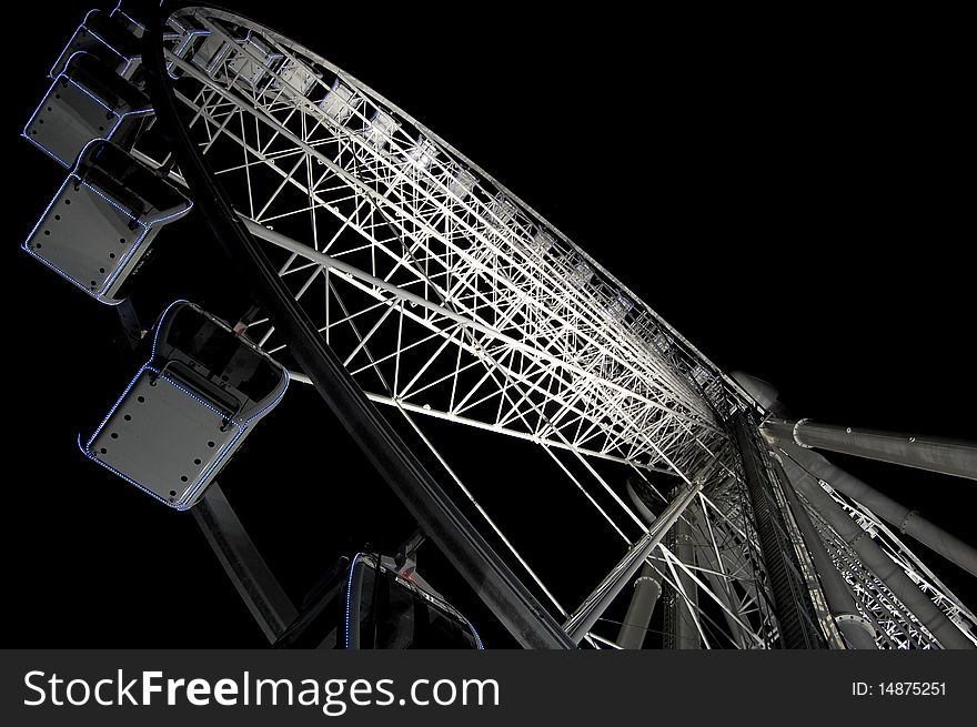A dynamic angle of the ferris wheel at night
