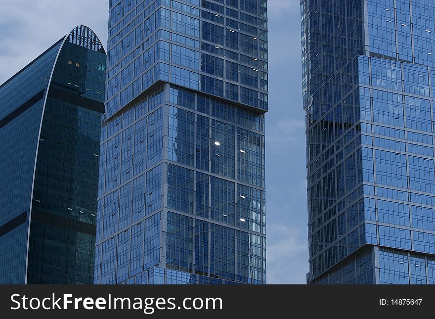 Reflection of a cloudy sky in glass wall of an office building