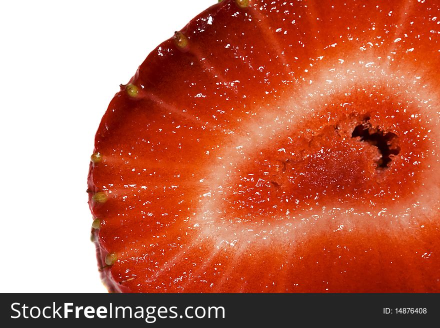 The mature red berry (strawberry), cut on a half, which section is photographed close up (macro). The mature red berry (strawberry), cut on a half, which section is photographed close up (macro)
