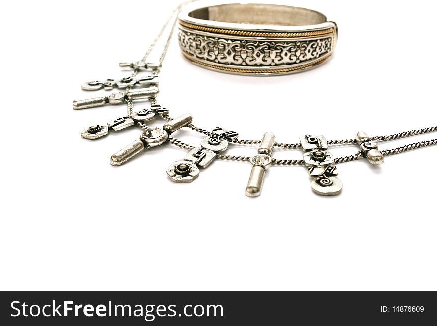 Silvery ancient style necklace and bracelet isolated on white background.