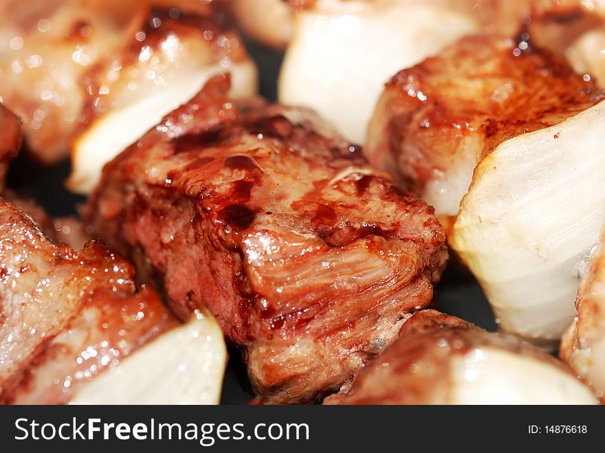 Juicy slices of meat with sauce prepare on fire. Juicy slices of meat with sauce prepare on fire