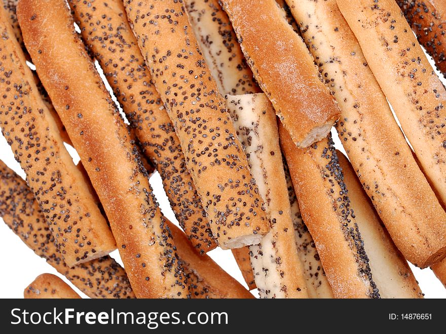 Stack of salted breadsticks with poppy seed isolated on white
