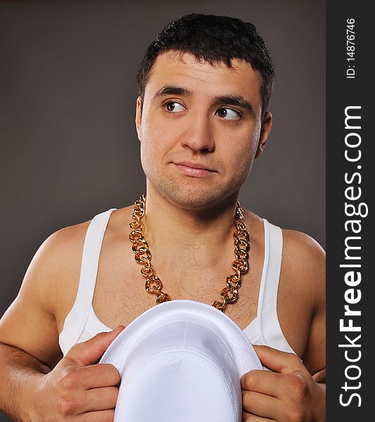 Stylish man holding white hat